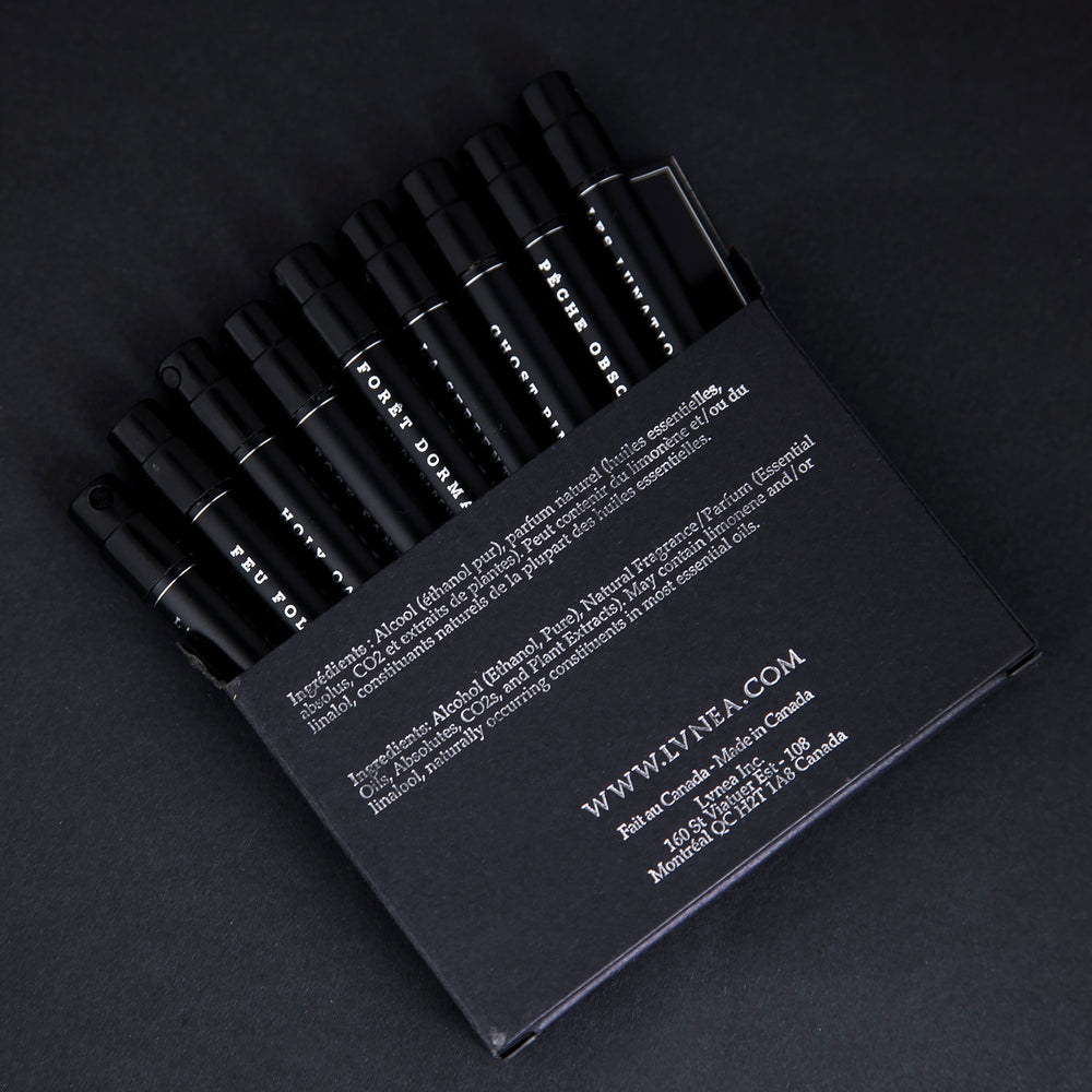 
                      
                        All 9 LVNEA eau de parfum samples peeking out from their black coardboard box, printed with silver foil
                      
                    