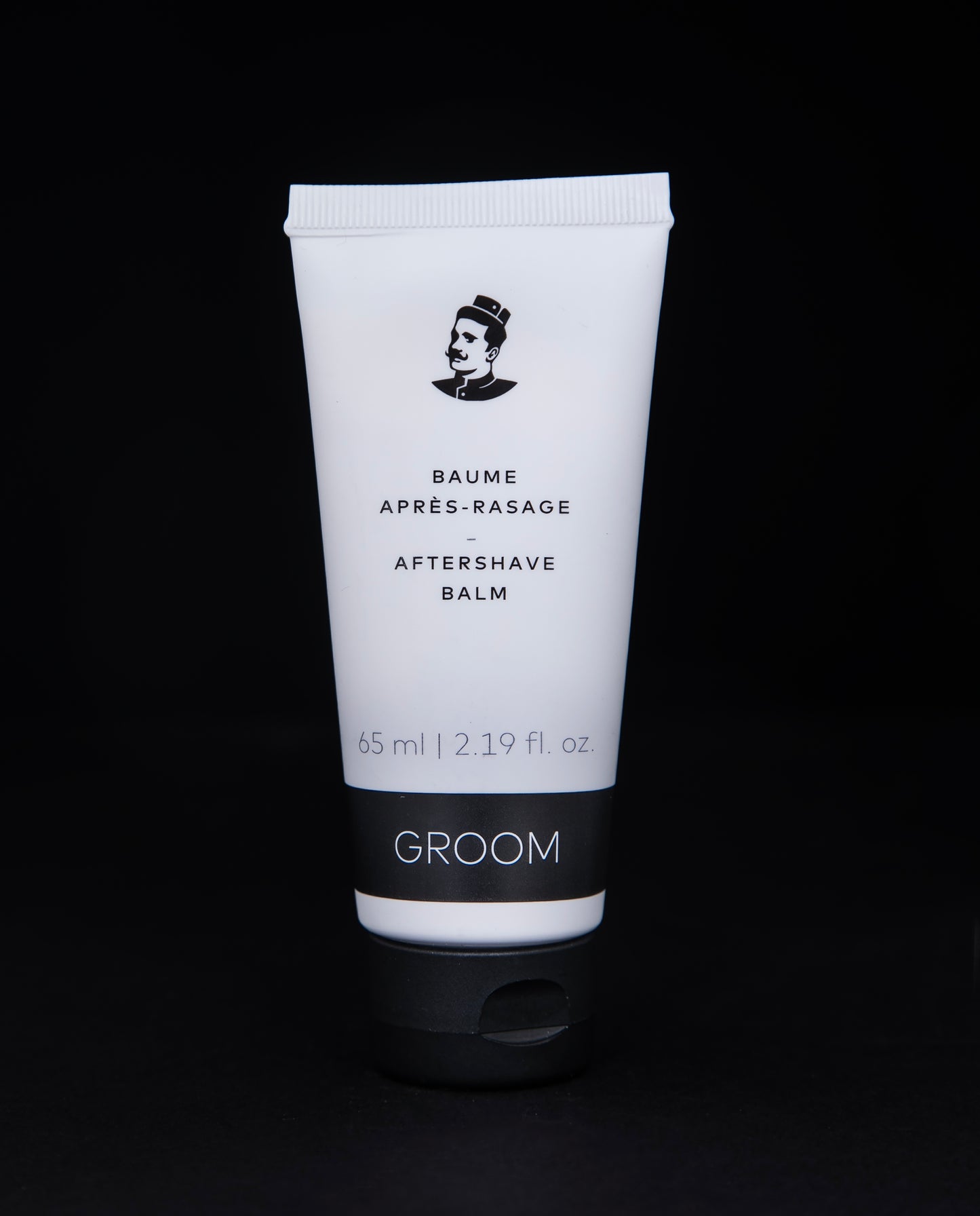 65ml white recycled plastic tube of aftershave against a black background