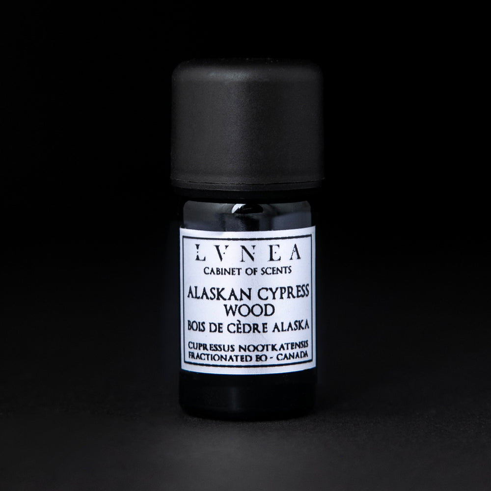 5ml black glass bottle of LVNEA's Alaskan Cypress Wood fractionated essential oil on black background