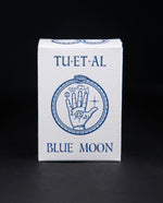 White cardboard soap box containing TU-ET-AL's "Blue Moon" soap. There is an illustration of a snake eating it's own tail, and an alchemical hand on front in blue.