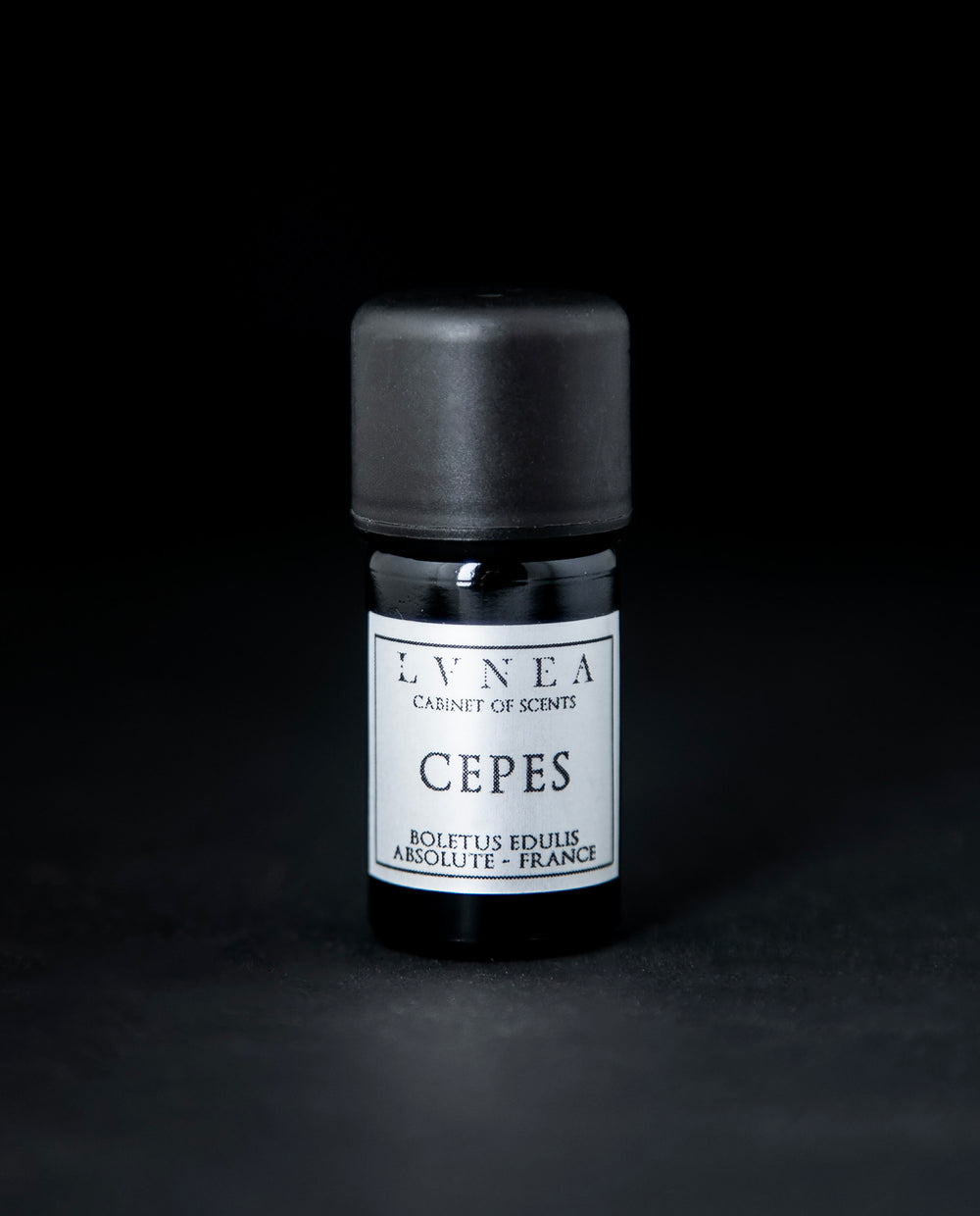 5ml black glass bottle with silver label of LVNEA's cepes absolute on black background