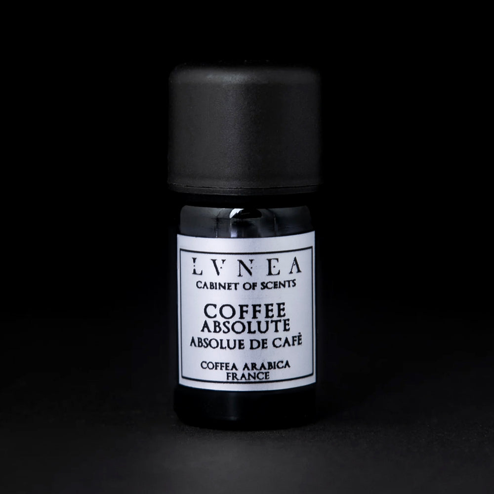 5ml black glass bottle of coffee absolute on a black background