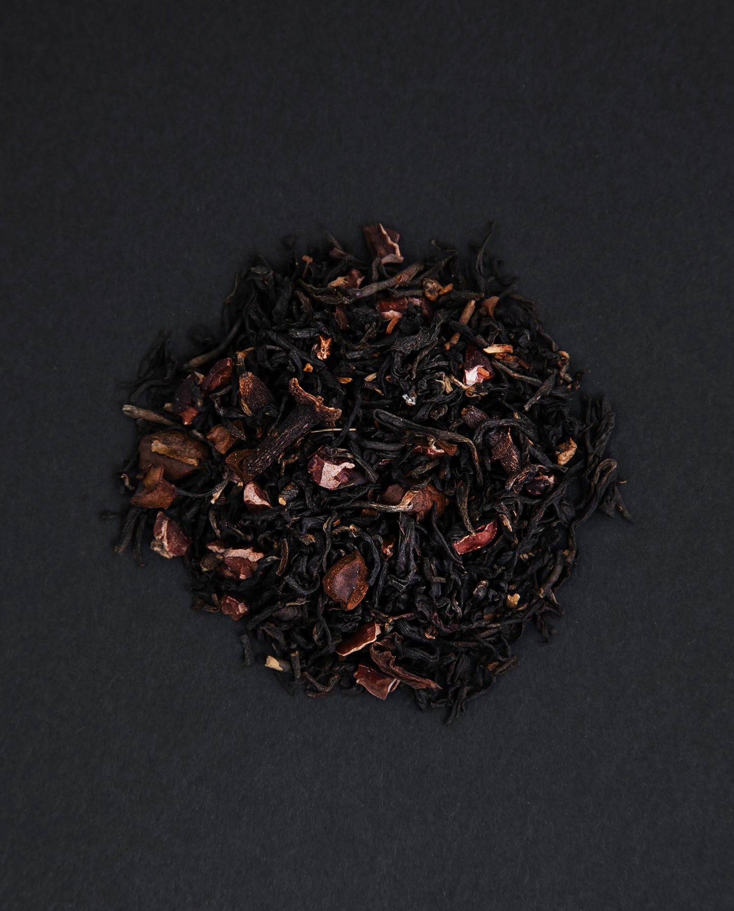 small pile of colombian breakfast chai viewed from above against a black background