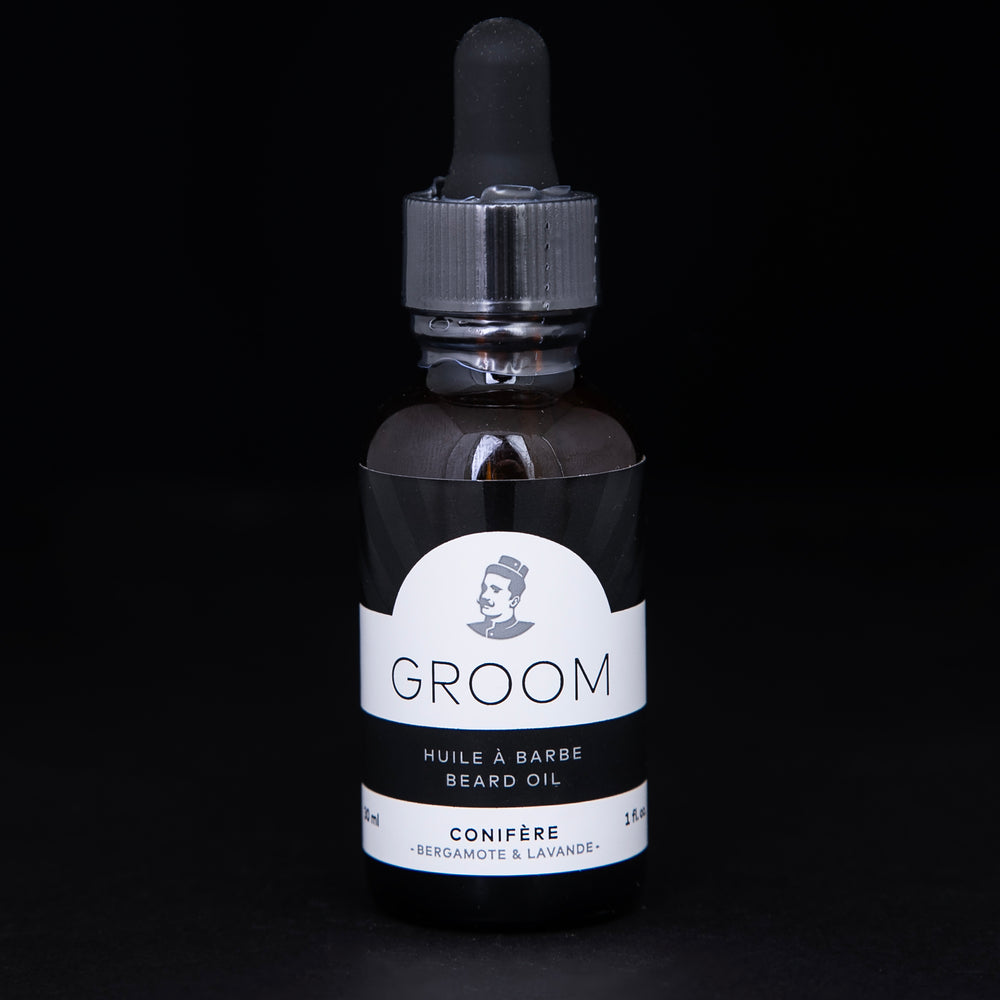 30ml amber glass bottle of Conifère beard oil against a black background