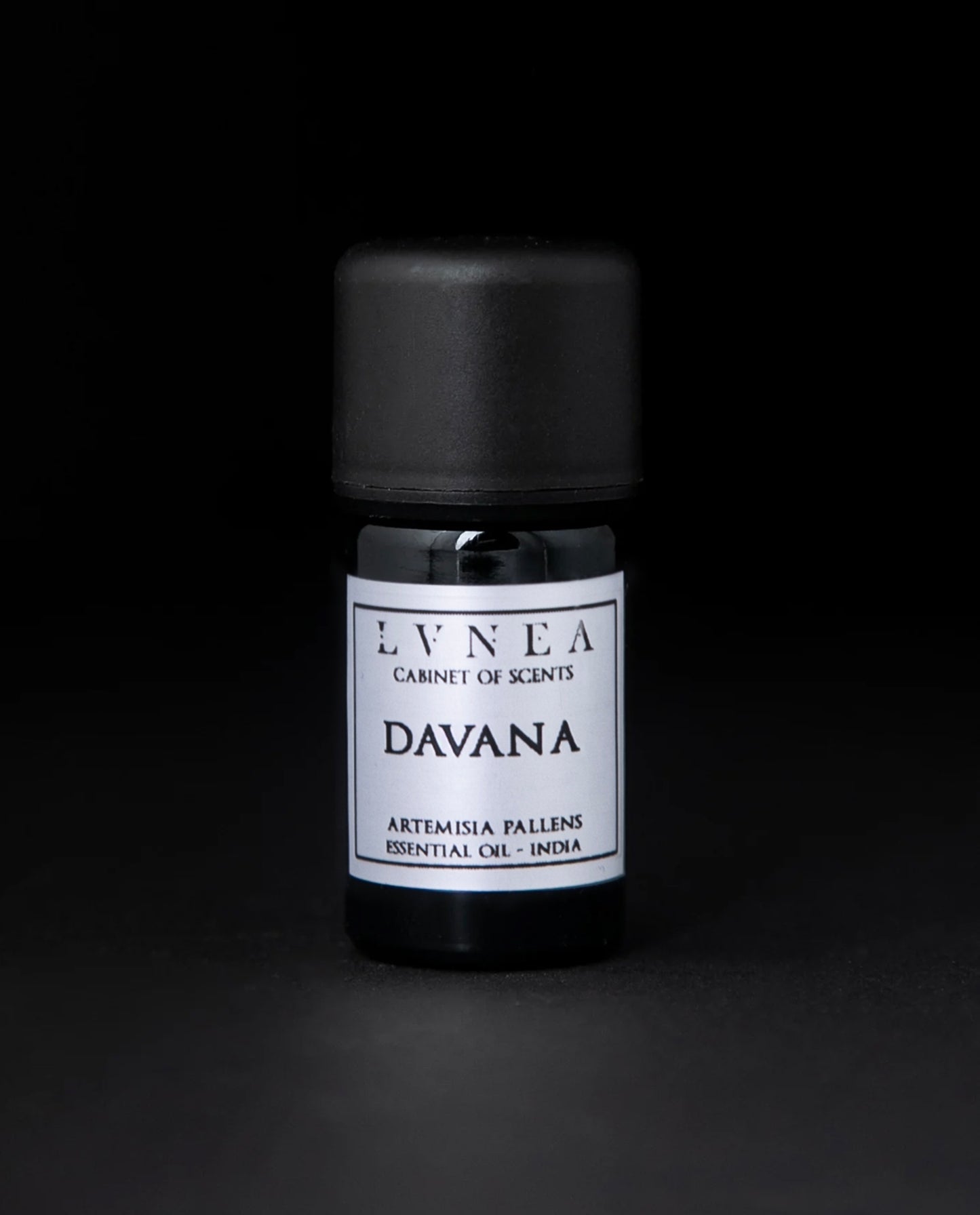 5ml black glass bottle of Davana essential oil against a black background