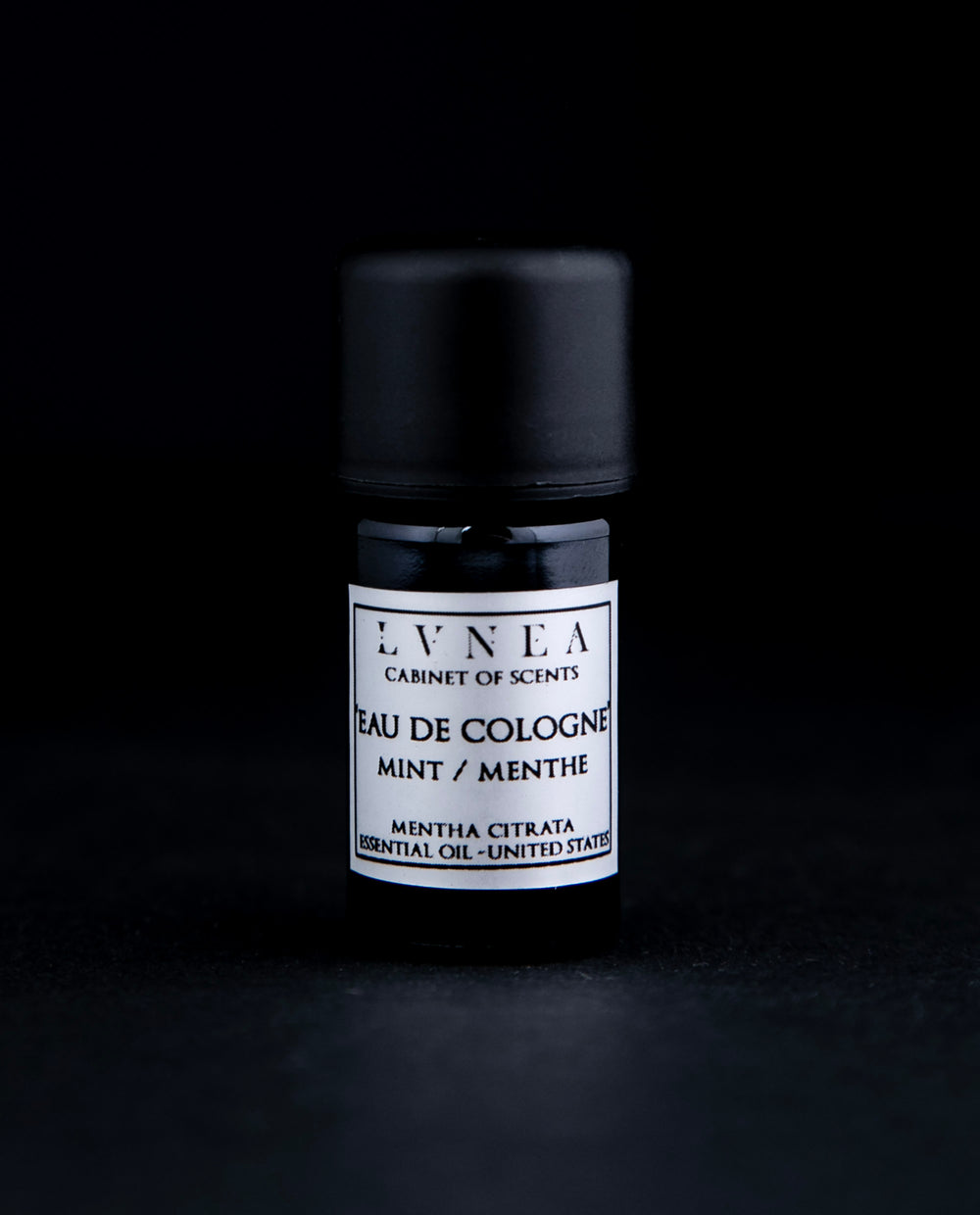 5ml black glass bottle of LVNEA's Eau de Cologne Mint on black background