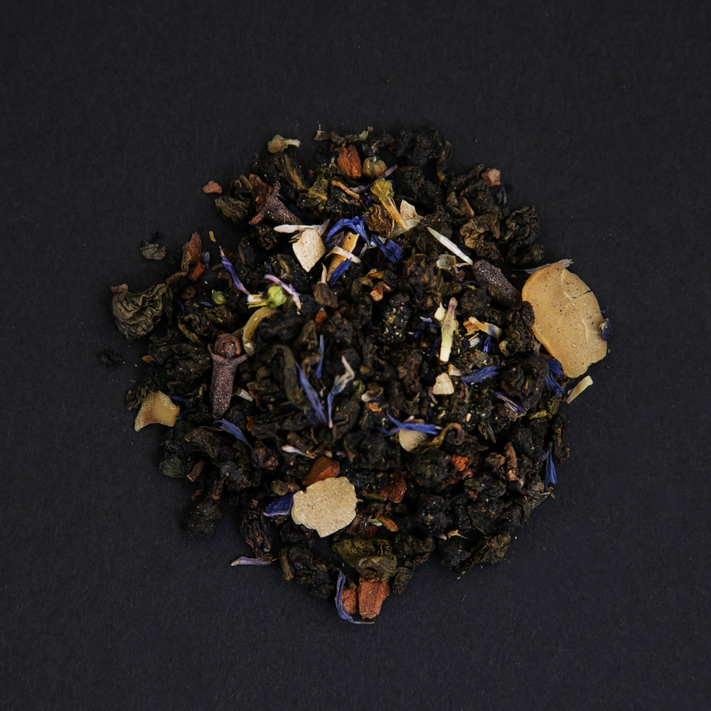 small pile of "flower moon" tea viewed from above against a black background