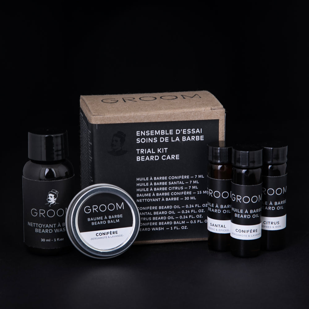 GROOM's "Beard Care Trial Kit" against a black background. The kit is composed of 3 beard oil samples in glass vials, one beard balm sample in a metal tin, and one beard wash sample in a small squeeze bottle, all enclosed in a cardboard box.