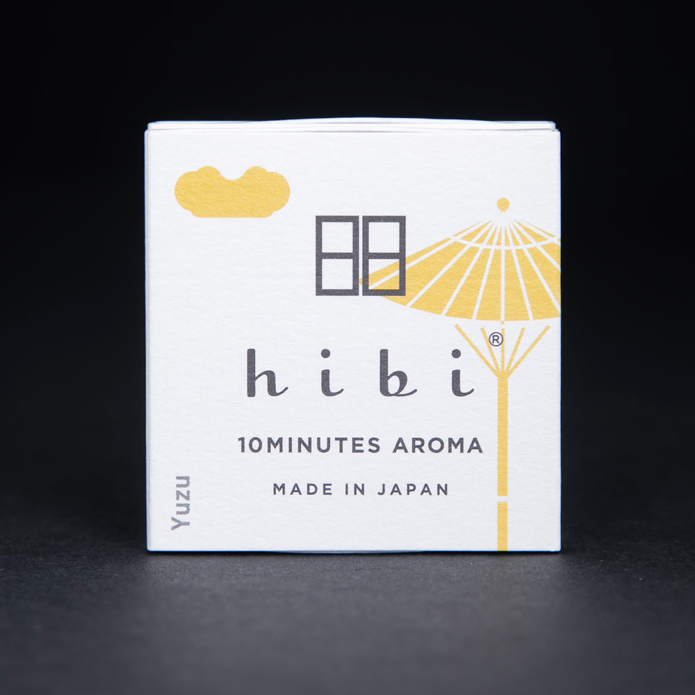 white paper box containing HIBI "yuzu" incense matches on black background