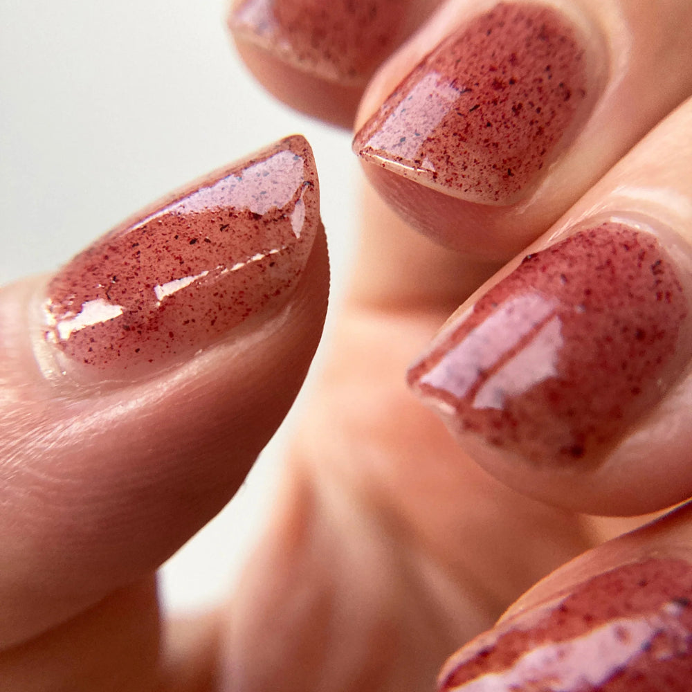 
                      
                        Close up of nails painted with Death Valley Nails' "Hibiscus and Beet Root" nail polish
                      
                    