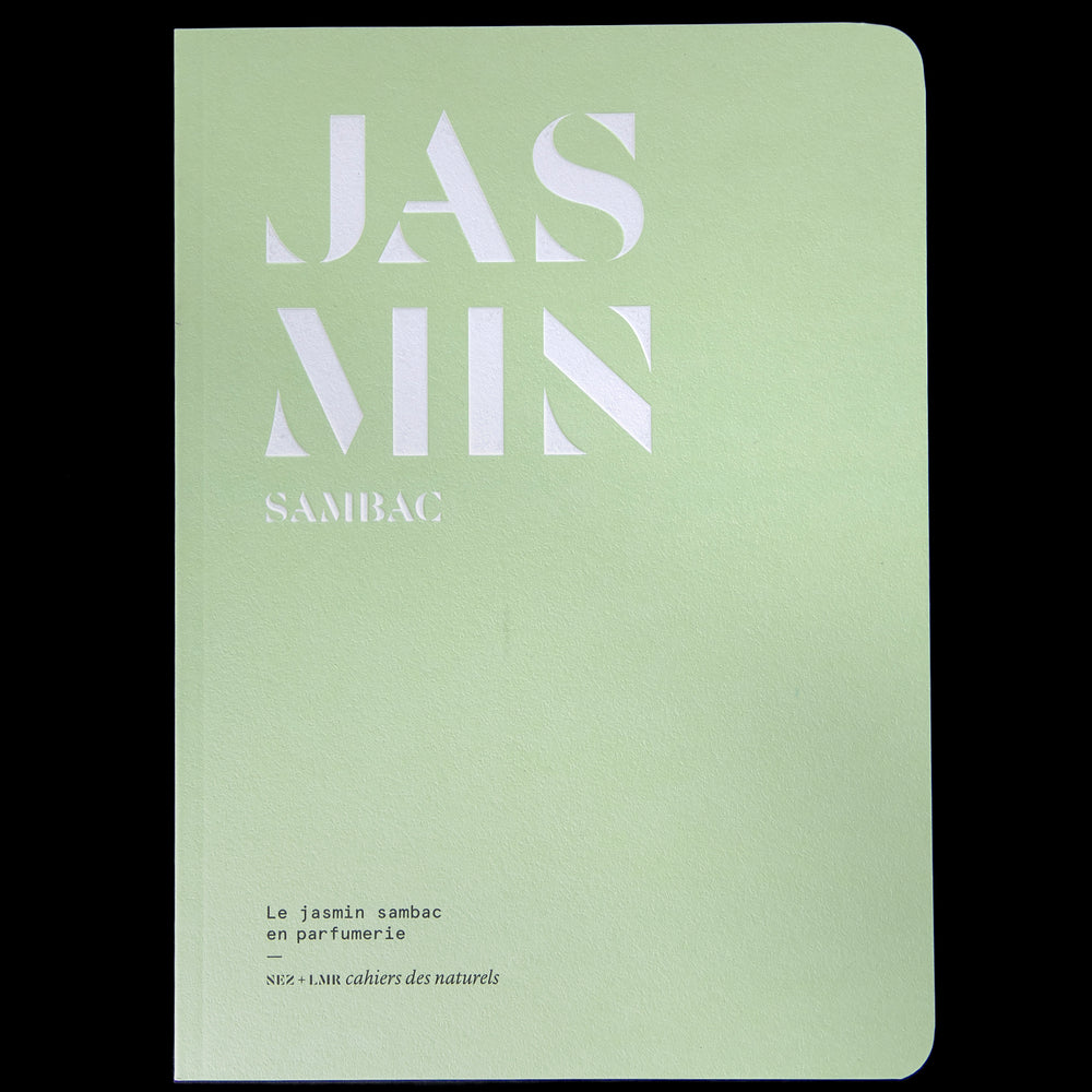 The book "Le jasmin sambac en parfumerie" against a black background. The book is pale green, with the word "JASMIN" written on the cover in bold graphic white lettering