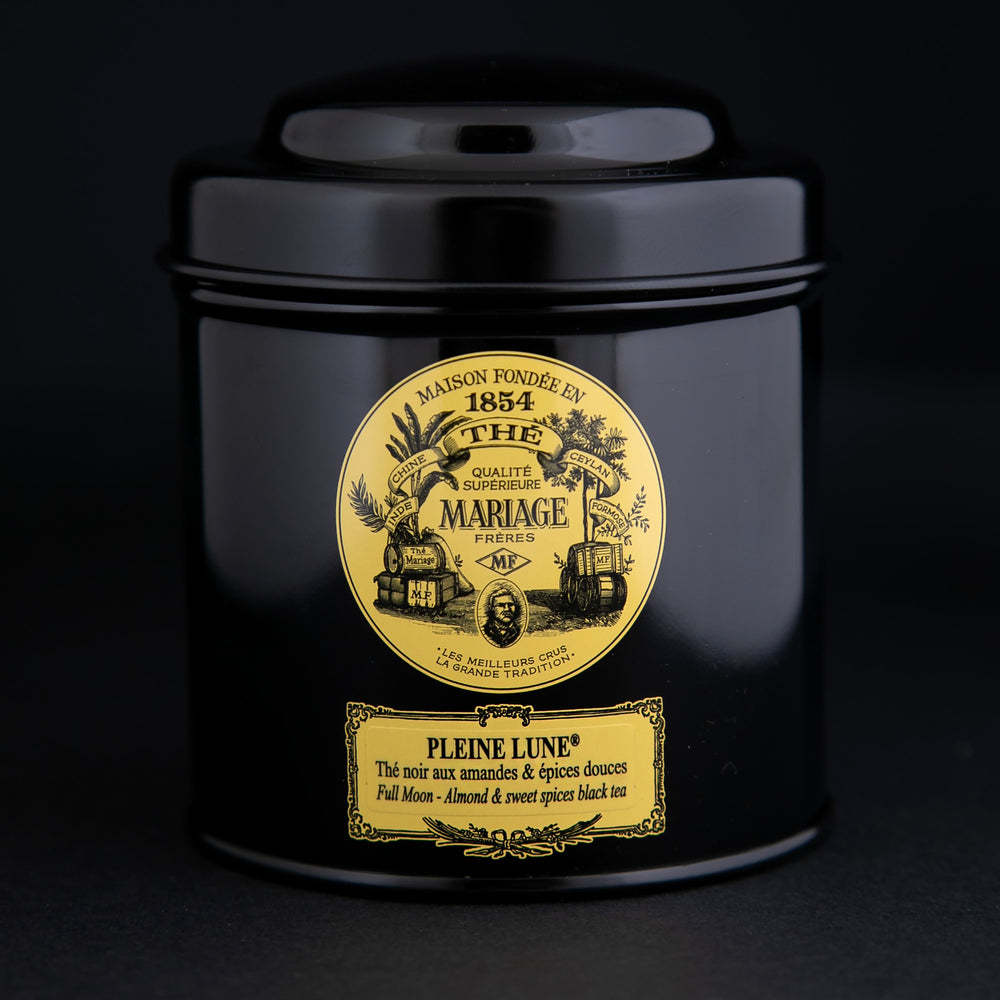 100g black laquered metal canister of Mariage Frère's "Pleine Lune" tea blend on black background.