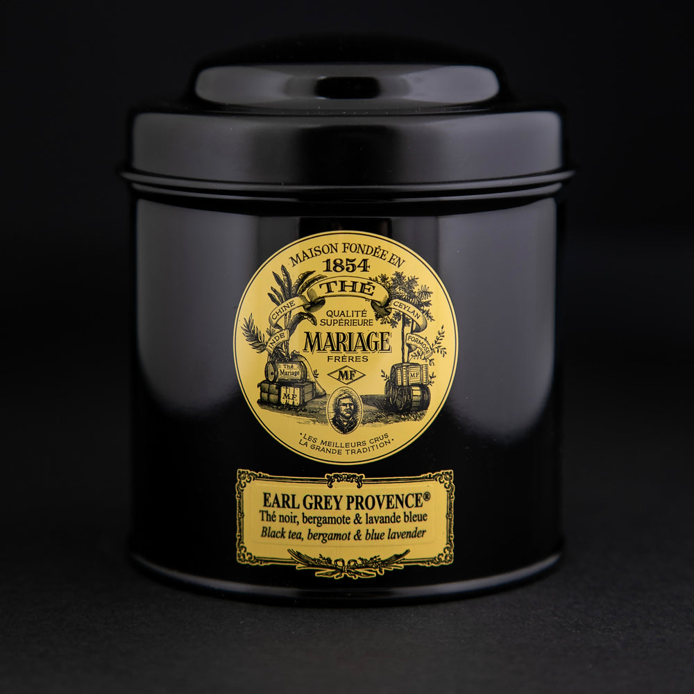 100g black laquered metal canister of Mariage Frère's "Earl Grey Provence" tea blend on black background.