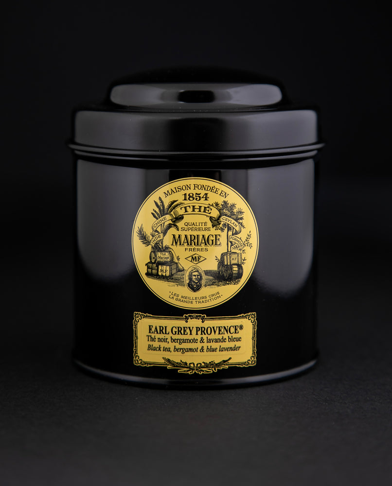 100g black laquered metal canister of Mariage Frère's "Earl Grey Provence" tea blend on black background.