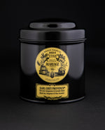 100g black laquered metal canister of Mariage Frère's "Earl Grey Provence" tea blend on black background.