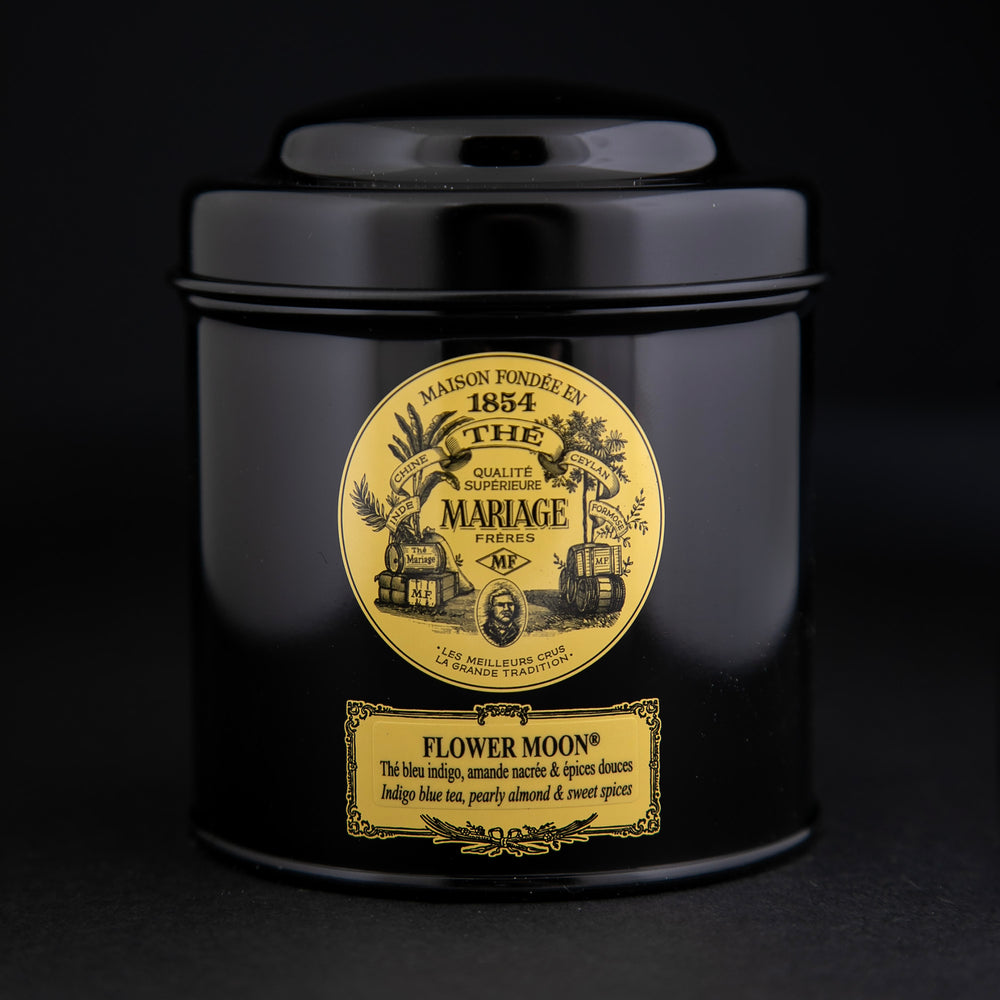 100g black laquered metal canister of Mariage Frère's "Flower Moon" tea blend on black background.