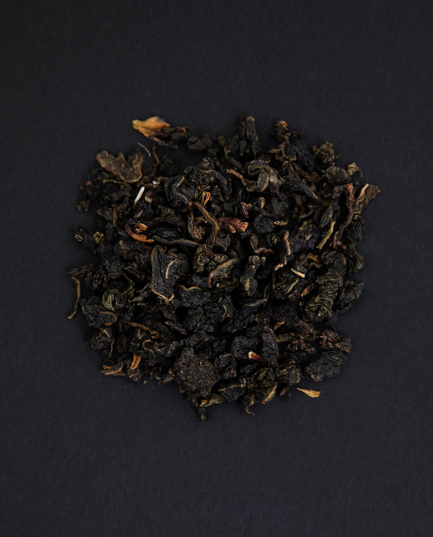 small pile of "milky blue absolut" tea viewed from above against a black background