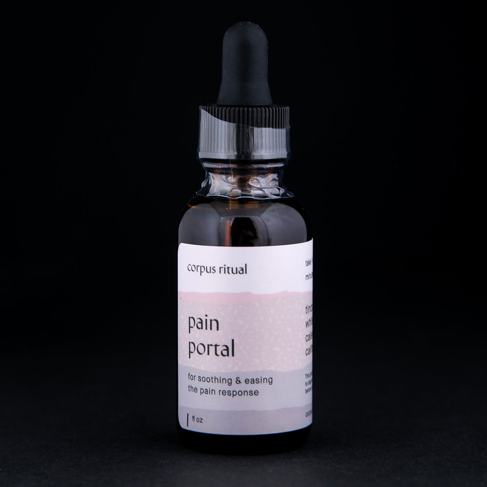 1oz glass amber bottle with black dropper top contains Corpus Ritual's "Pain Portal" tincture on black background