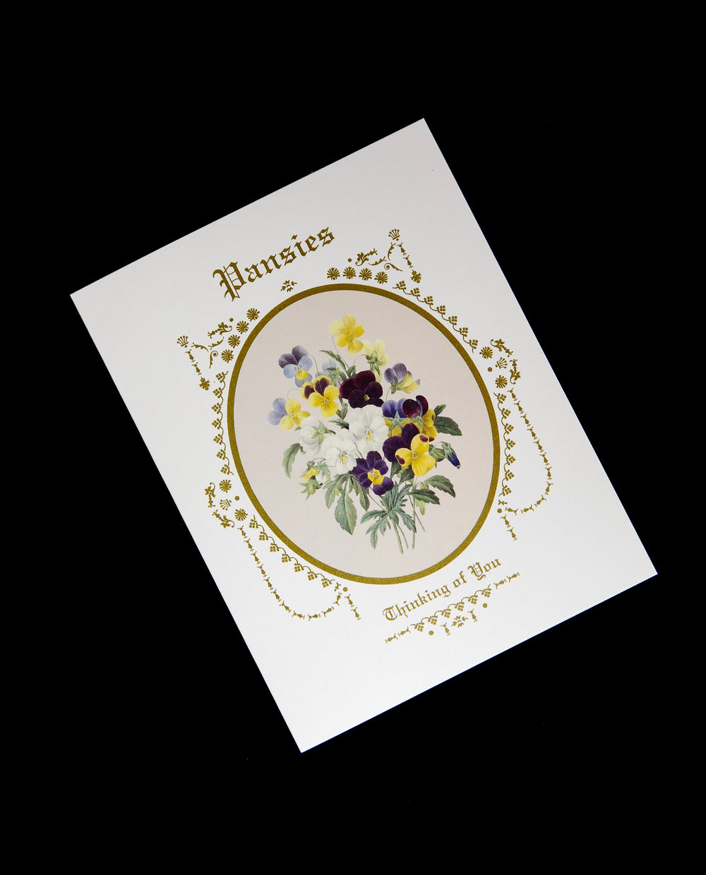 white greeing card featuring an illustration of pansies surrounded by a gilded frame