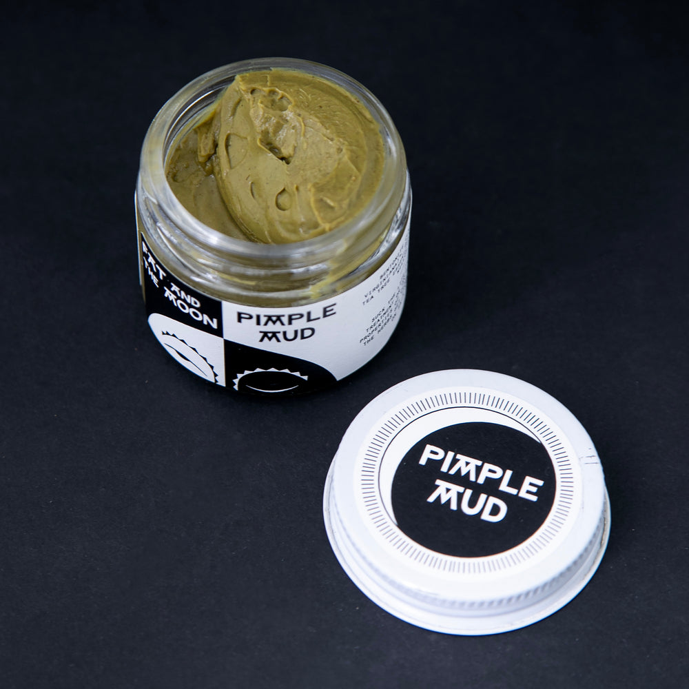 opened glass jar of Fat and the Moon's "Pimple Mud", revealing a thick yellowy green clay-based paste