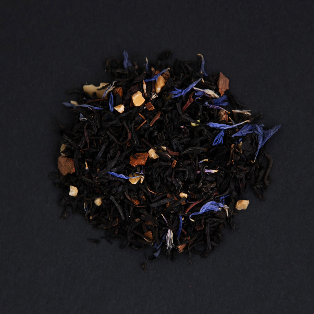 small pile of "pleine lune" tea viewed from above against a black background