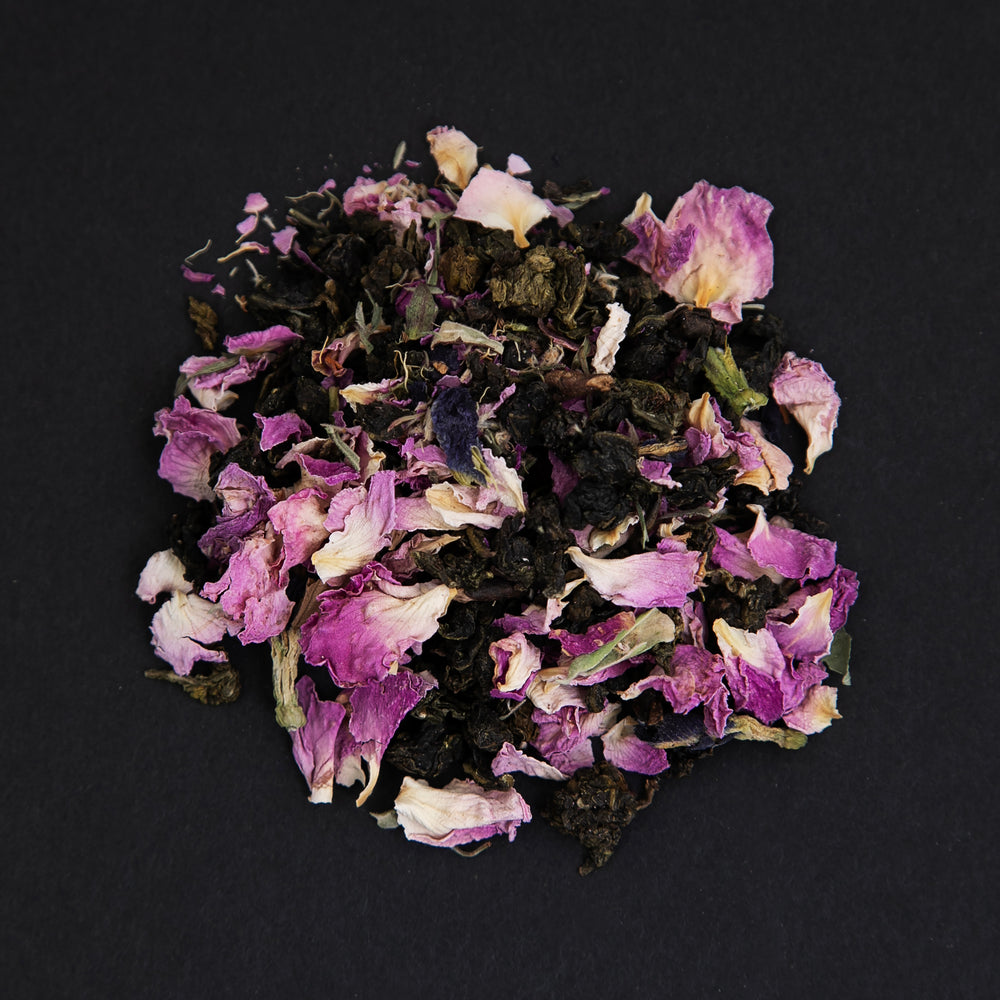 
                      
                        small pile of "rose d'amour" tea viewed from above against a black background
                      
                    