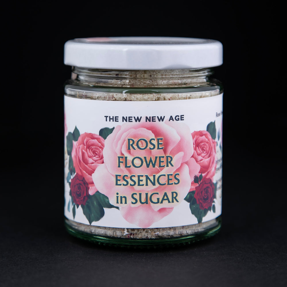 
                      
                        130g clear glass jar of The New New Age's "Rose Flower Essences in Sugar". There are illustrations of roses on the label.
                      
                    