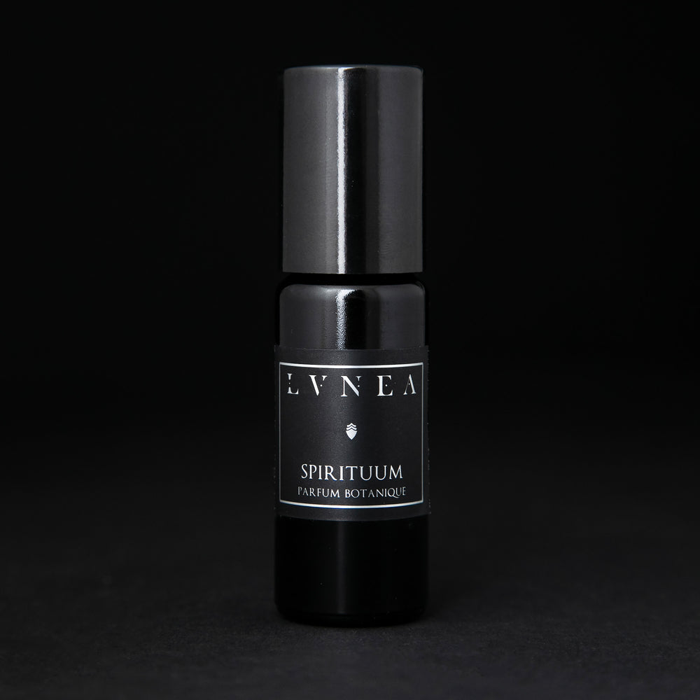 10ml black glass bottle of LVNEA's Spirituum natural roll on perfume oil on black background