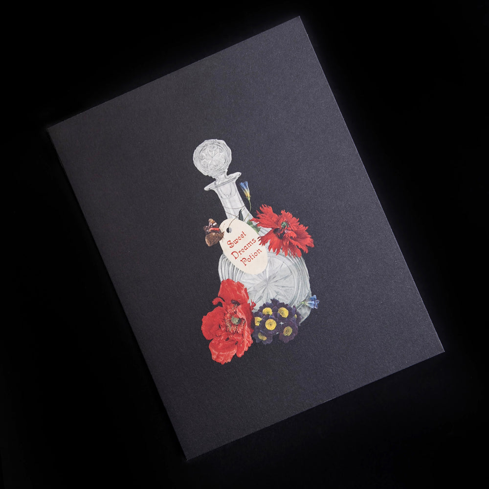 black greeting card with illustration of vintage glass bottle and red botanicals