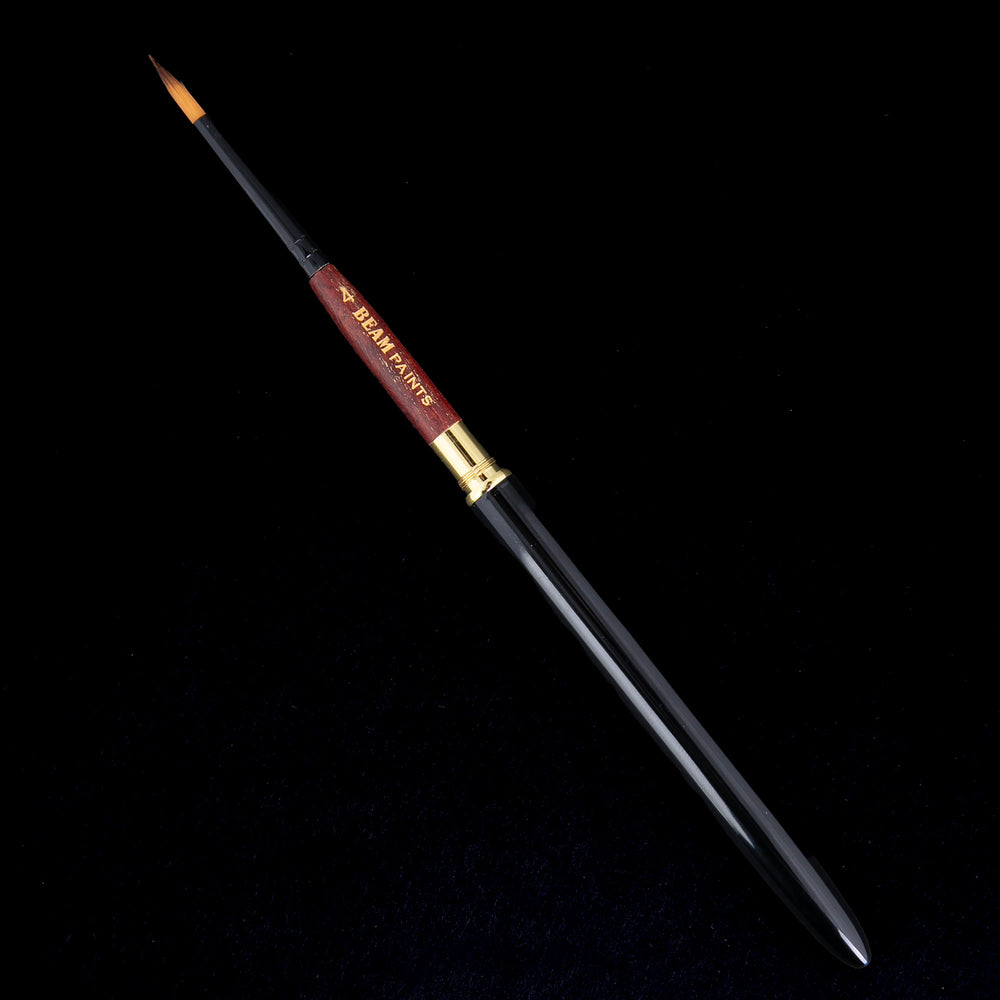 beam paints travel brush against a black background. the brush has a black metal handle and wooden neck.