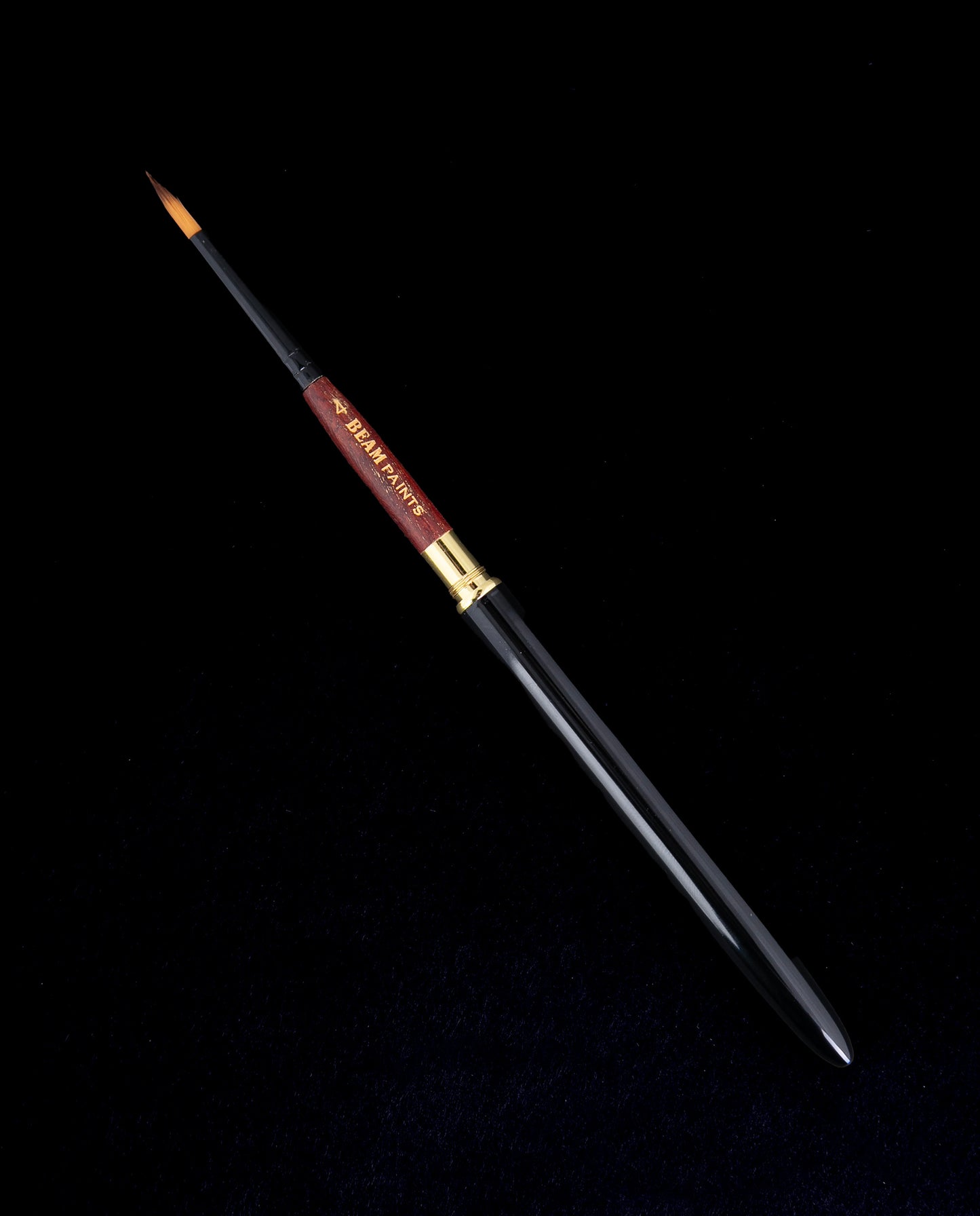 beam paints travel brush against a black background. the brush has a black metal handle and wooden neck.