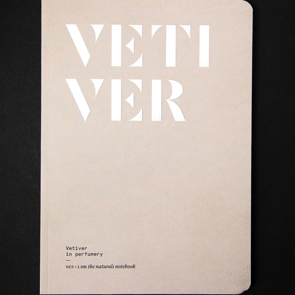 The book "Vetiver in Perfumery" on a black background. The cover is a light tan colour and reads "VETIVER" in bold white graphic letters.