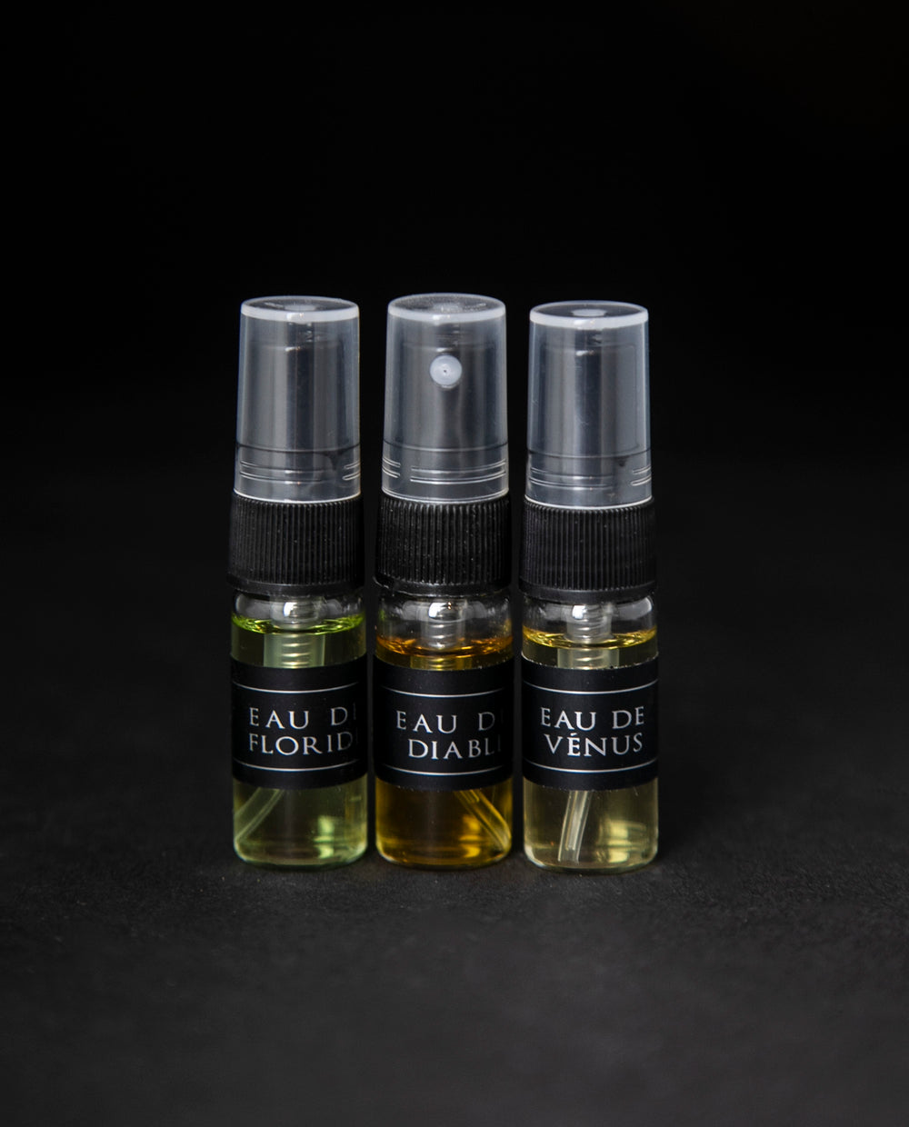 Full sample set of LVNEA's Eau de Cologne collection on black background. Includes Eau de Floride, Eau du Diable and Eau de Venus, each in a 3ml spray top glass bottle.