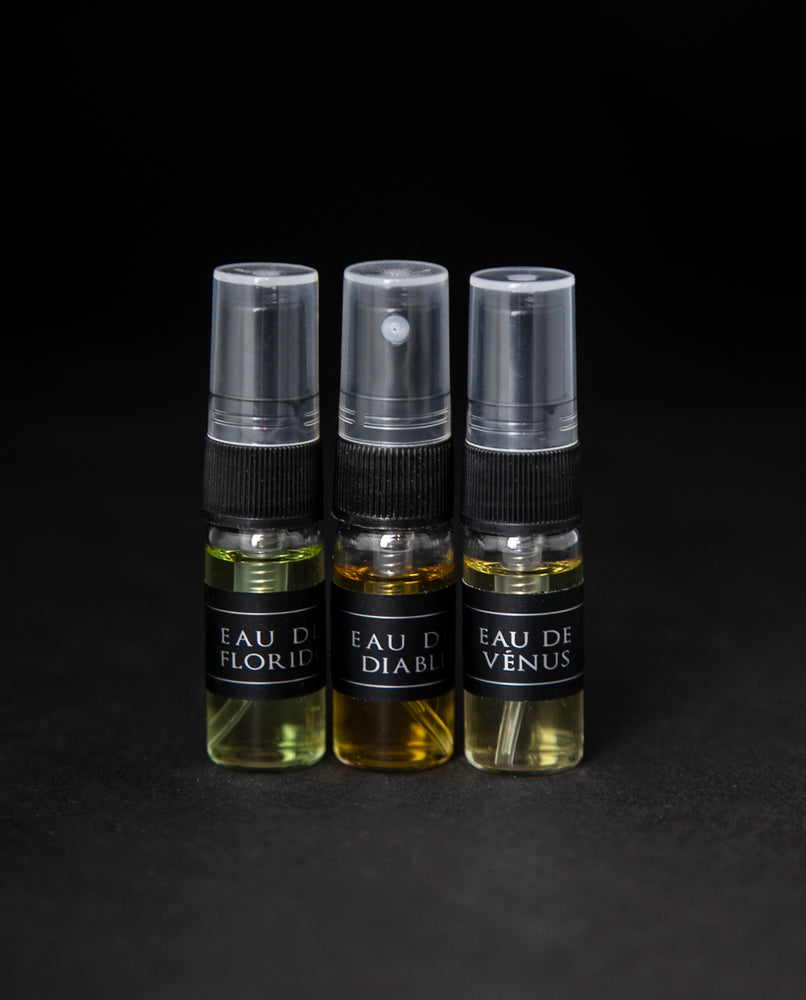 Full sample set of LVNEA's Eau de Cologne collection on black background. Includes Eau de Floride, Eau du Diable and Eau de Venus, each in a 3ml spray top glass bottle.