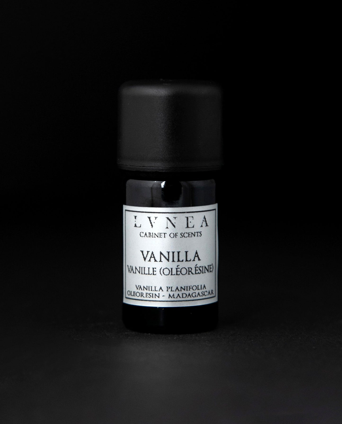 5ml black glass bottle of LVNEA's vanilla oleoresin on black background. The label on the bottle is silver.